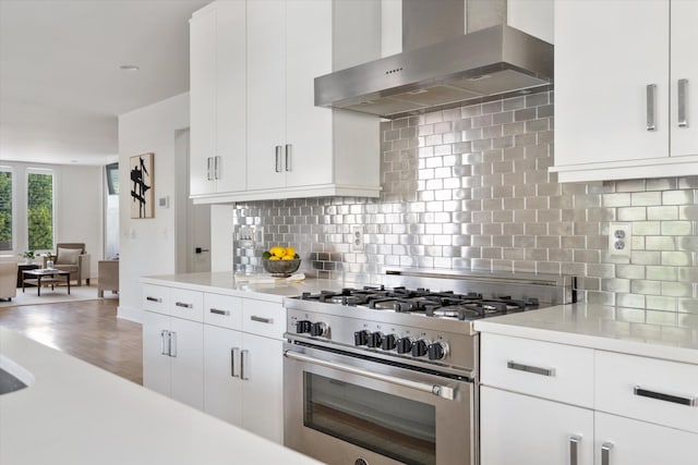 814A Horner Ave, Nashville, TN 37204 - kitchen with wall chimney range hood, stainless steel range, light countertops, and decorative backsplash