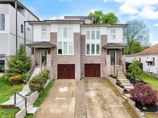 814A Horner Ave, Nashville, TN 37204 - view of front of house featuring stairs, concrete driveway, a garage, and stucco siding
