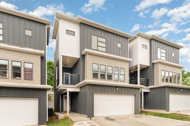 3802B Hutson Ave, Nashville, TN 37216 - view of front of home featuring a garage, a balcony, cooling unit, concrete driveway, and board and batten siding