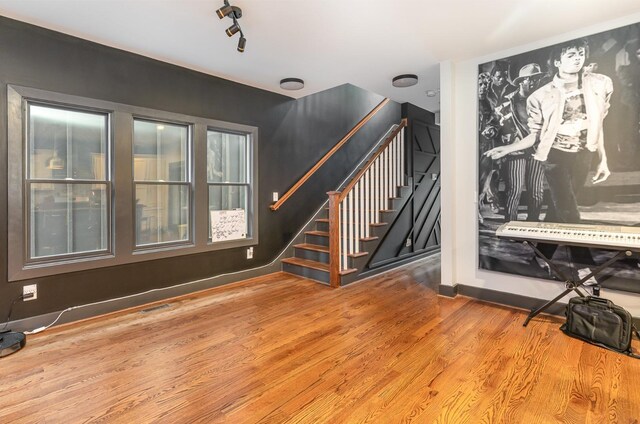 3802B Hutson Ave, Nashville, TN 37216 - unfurnished living room featuring wood finished floors, stairs, and baseboards