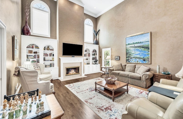 113 Abbeywood Dr, Nashville, TN 37215 - living room with a high ceiling, ornamental molding, built in shelves, dark wood-type flooring, and a high end fireplace