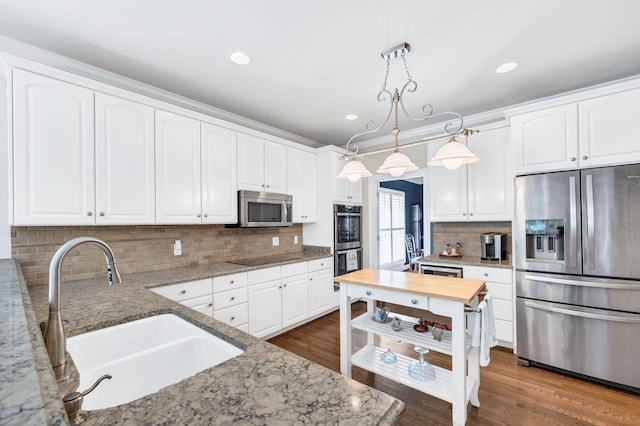 113 Abbeywood Dr, Nashville, TN 37215 - kitchen with stainless steel appliances, a sink, light stone countertops, backsplash, and recessed lighting