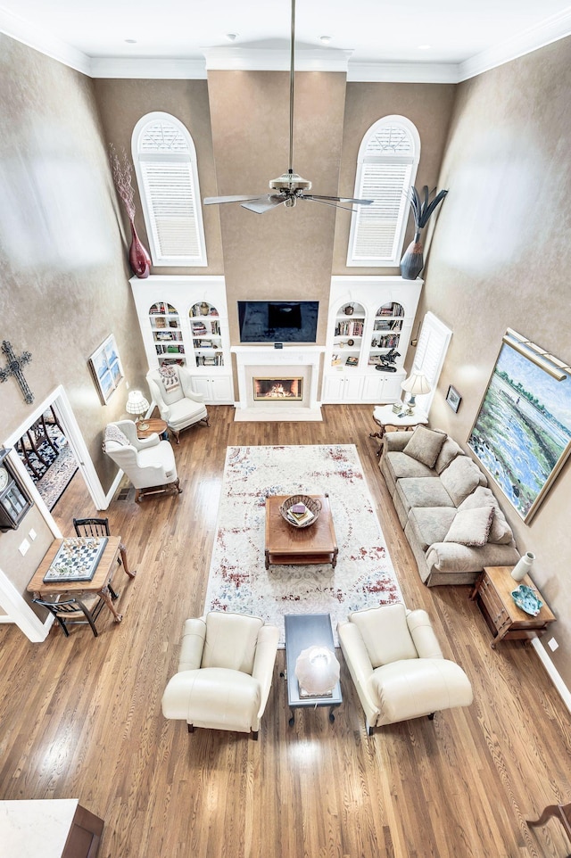 113 Abbeywood Dr, Nashville, TN 37215 - living room featuring a towering ceiling, wood finished floors, ornamental molding, ceiling fan, and a fireplace