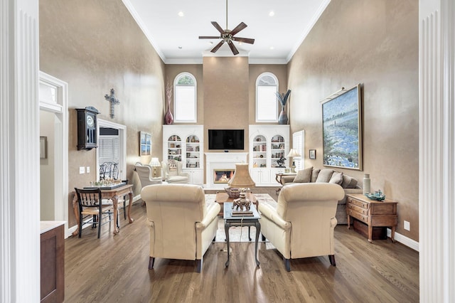 113 Abbeywood Dr, Nashville, TN 37215 - living room with a towering ceiling, a ceiling fan, a lit fireplace, wood finished floors, and built in shelves