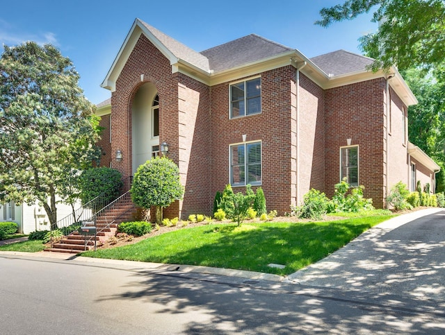 113 Abbeywood Dr, Nashville, TN 37215 - traditional-style house featuring brick siding, roof with shingles, and a front yard