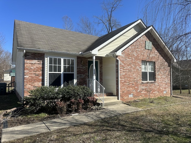view of front of house with brick siding and a shingled roof