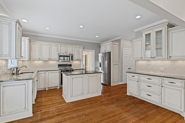55 Revere Park, Nashville, TN 37205 - kitchen with appliances with stainless steel finishes, a sink, decorative backsplash, dark stone countertops, and dark wood-style floors