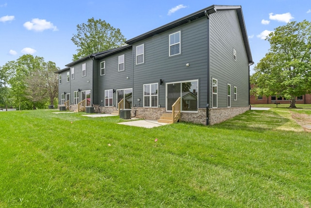 217 S Porter St S Unit 217, Winchester, TN 37398 - back of property featuring entry steps, central AC unit, brick siding, and a yard