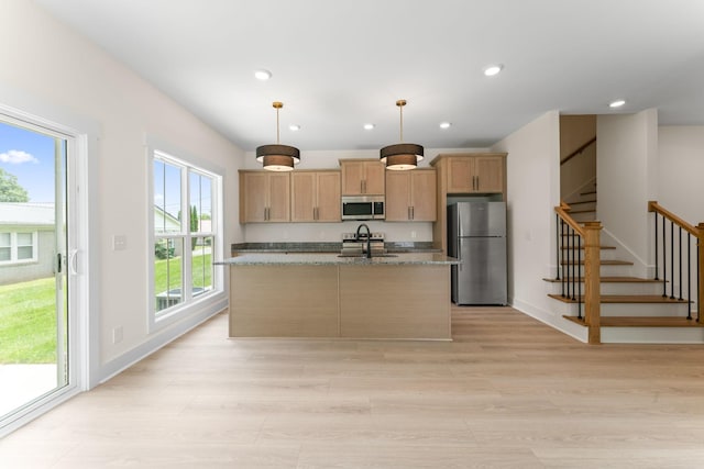 217 S Porter St S Unit 217, Winchester, TN 37398 - kitchen with appliances with stainless steel finishes, a sink, a kitchen island with sink, light wood-style floors, and recessed lighting