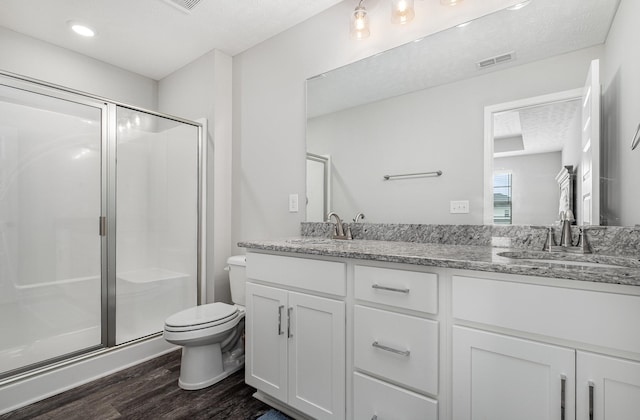 1840 Bethpage Dr, Murfreesboro, TN 37127 - full bathroom with wood finished floors, toilet, a stall shower, double vanity, and a textured ceiling