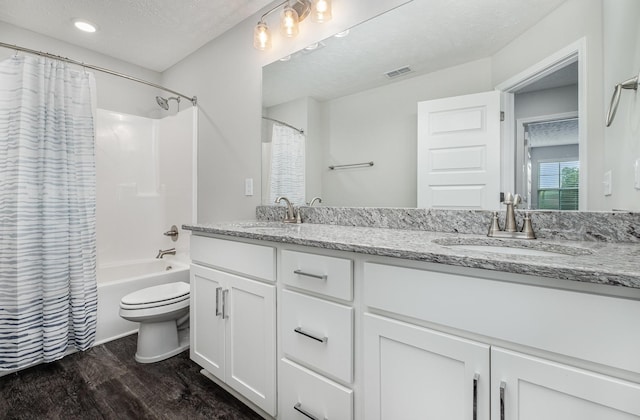 1840 Bethpage Dr, Murfreesboro, TN 37127 - full bathroom featuring wood finished floors, double vanity, toilet, shower / bathtub combination with curtain, and a textured ceiling