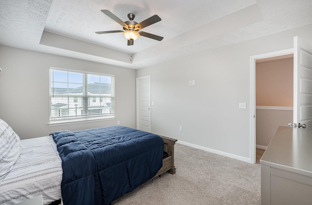 1840 Bethpage Dr, Murfreesboro, TN 37127 - bedroom with a tray ceiling, light carpet, a textured ceiling, baseboards, and a ceiling fan