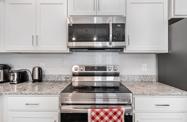 1840 Bethpage Dr, Murfreesboro, TN 37127 - kitchen with appliances with stainless steel finishes, white cabinets, and light stone countertops
