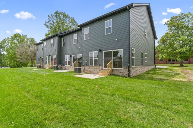 215 S Porter St Unit 215, Winchester, TN 37398 - back of property with entry steps, cooling unit, a yard, and brick siding