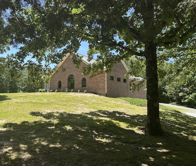 110 Hankins Rd, Hohenwald, TN 38462 - view of side of home featuring a lawn and brick siding