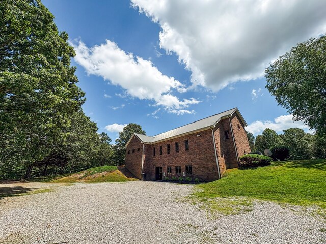 110 Hankins Rd, Hohenwald, TN 38462 - view of front of house featuring driveway, brick siding, and a front yard