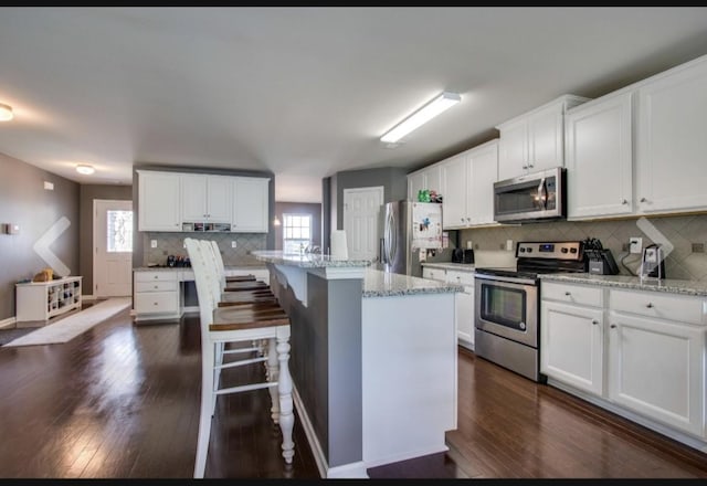 1470 Old Stone Rd, Lebanon, TN 37087 - kitchen featuring appliances with stainless steel finishes, decorative backsplash, dark wood finished floors, and white cabinetry