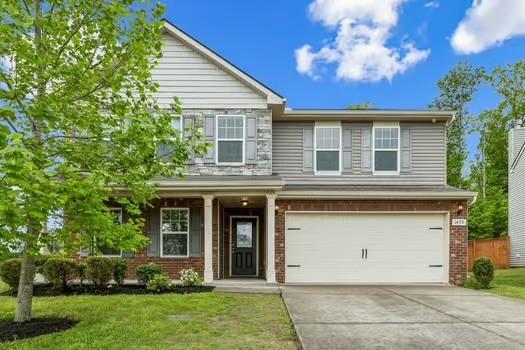 1470 Old Stone Rd, Lebanon, TN 37087 - view of front facade with a garage, brick siding, and concrete driveway