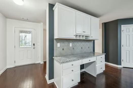 1470 Old Stone Rd, Lebanon, TN 37087 - kitchen featuring dark wood finished floors, white cabinetry, baseboards, tasteful backsplash, and light stone counters