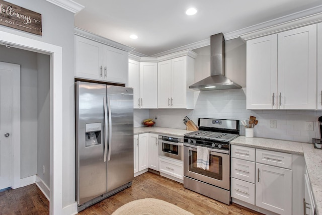 6214A California Ave, Nashville, TN 37209 - kitchen featuring stainless steel appliances, wall chimney exhaust hood, light wood-type flooring, decorative backsplash, and ornamental molding