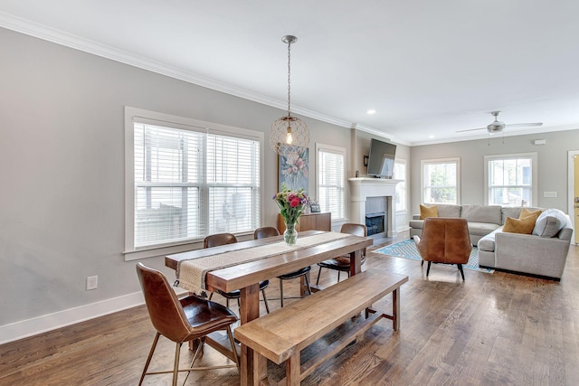 6214A California Ave, Nashville, TN 37209 - dining room featuring crown molding, a fireplace, baseboards, wood finished floors, and a ceiling fan