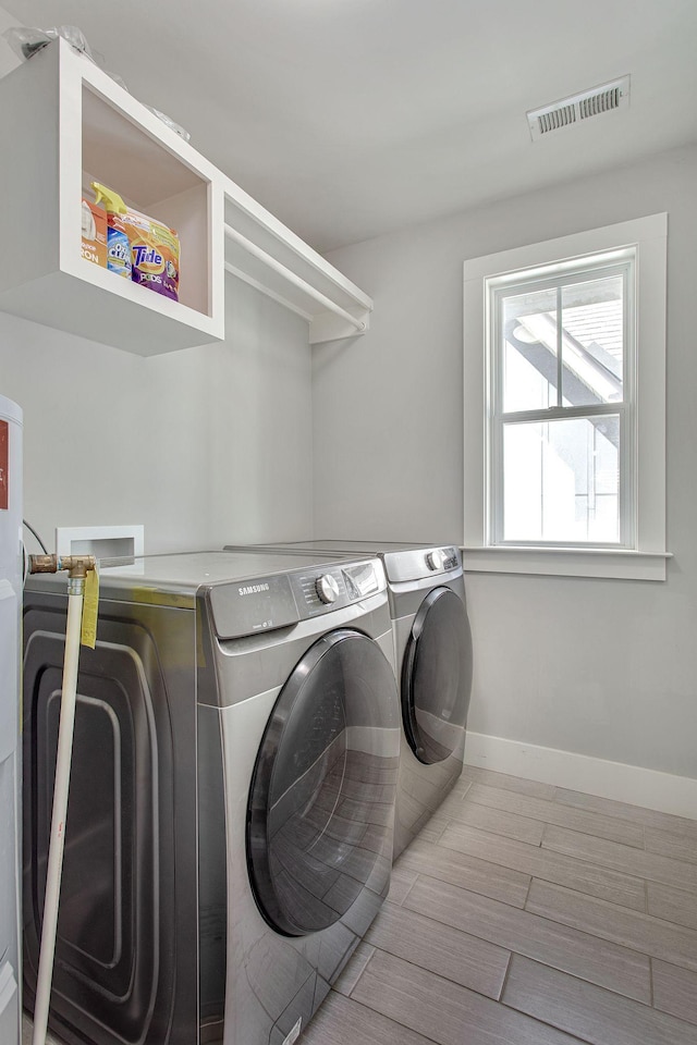 6214A California Ave, Nashville, TN 37209 - washroom featuring washing machine and clothes dryer, baseboards, and wood finished floors