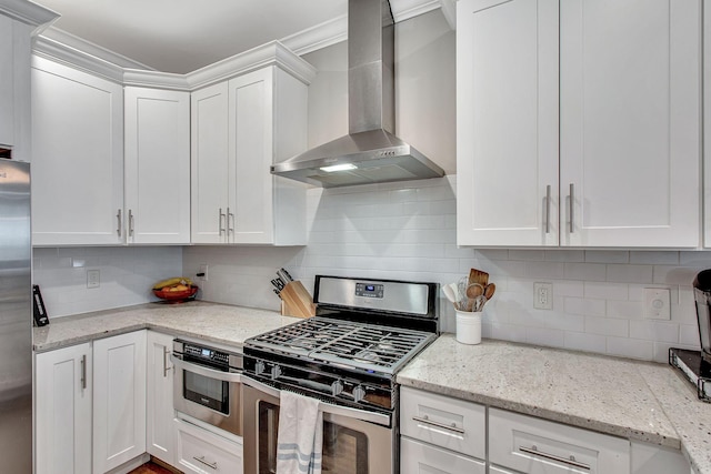 6214A California Ave, Nashville, TN 37209 - kitchen with stainless steel appliances, wall chimney exhaust hood, white cabinetry, and tasteful backsplash