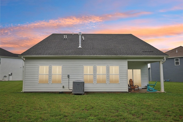 3706 Bonnie Blue Ct, Rockvale, TN 37153 - back of property at dusk featuring a yard, central AC, a shingled roof, and a patio