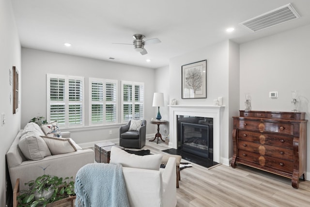 3706 Bonnie Blue Ct, Rockvale, TN 37153 - living room with ceiling fan, a glass covered fireplace, light wood-style floors, recessed lighting, and baseboards
