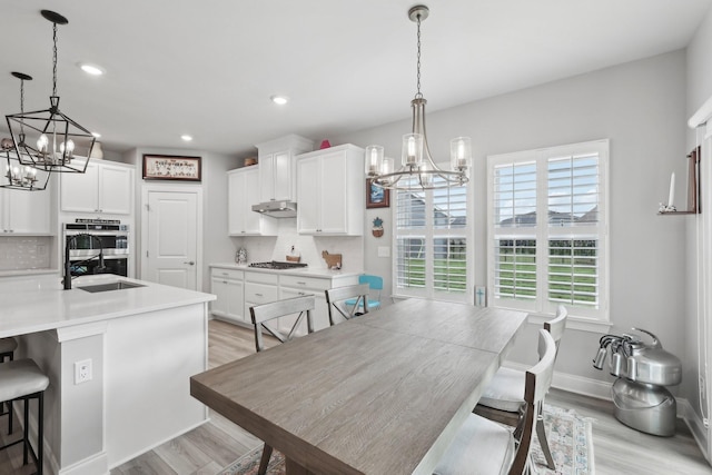 3706 Bonnie Blue Ct, Rockvale, TN 37153 - dining room with a chandelier, healthy amount of natural light, light wood-style floors, recessed lighting, and baseboards