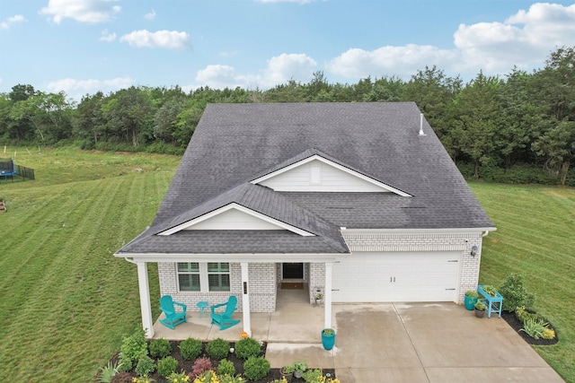 3706 Bonnie Blue Ct, Rockvale, TN 37153 - view of front of property with a trampoline, brick siding, a shingled roof, and a front yard