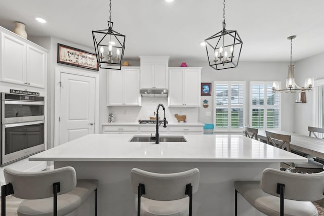 3706 Bonnie Blue Ct, Rockvale, TN 37153 - kitchen with a chandelier, double oven, a kitchen breakfast bar, and recessed lighting