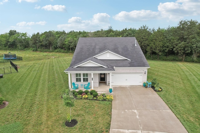 3706 Bonnie Blue Ct, Rockvale, TN 37153 - view of front facade featuring a trampoline, covered porch, brick siding, roof with shingles, and a front yard
