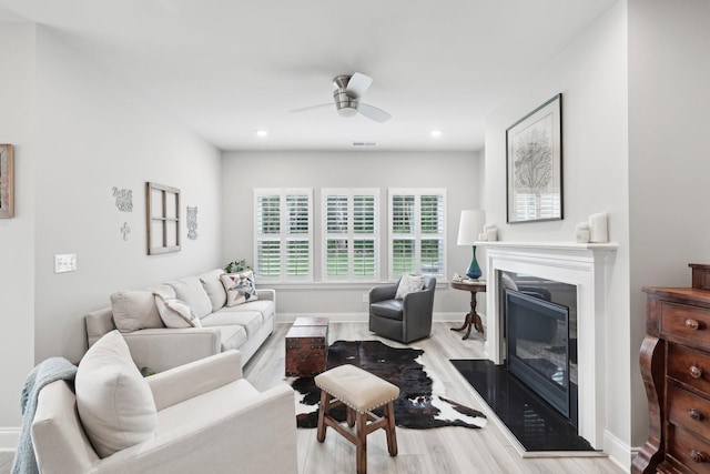 3706 Bonnie Blue Ct, Rockvale, TN 37153 - living room featuring wood finished floors, a ceiling fan, a glass covered fireplace, baseboards, and recessed lighting