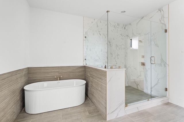 219 Chamberlin St, Nashville, TN 37209 - full bath with a marble finish shower, a soaking tub, tile walls, and tile patterned flooring