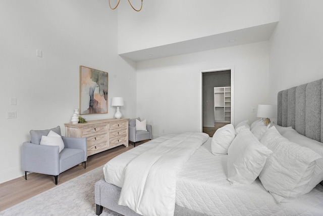 219 Chamberlin St, Nashville, TN 37209 - bedroom featuring wood finished floors, a spacious closet, a high ceiling, baseboards, and a closet