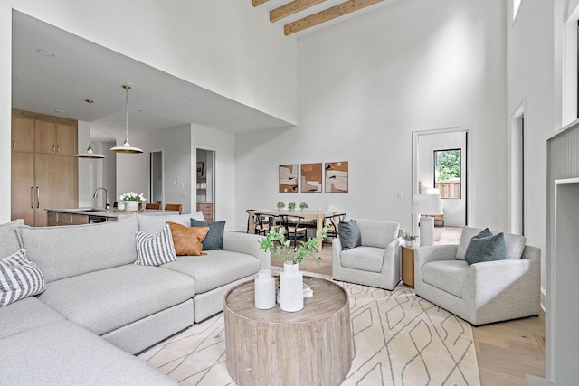219 Chamberlin St, Nashville, TN 37209 - living room featuring a towering ceiling, beam ceiling, and light wood finished floors