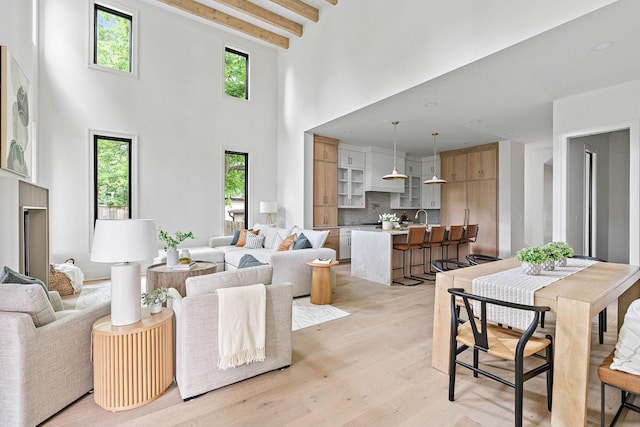 219 Chamberlin St, Nashville, TN 37209 - living room with light wood finished floors, a high ceiling, and beam ceiling
