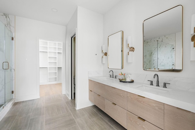 219 Chamberlin St, Nashville, TN 37209 - bathroom with a stall shower, a spacious closet, double vanity, and baseboards