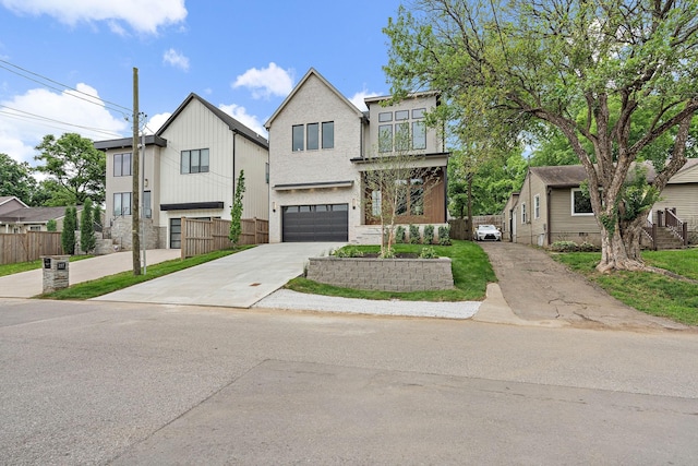 219 Chamberlin St, Nashville, TN 37209 - view of front of property featuring driveway, fence, and a garage