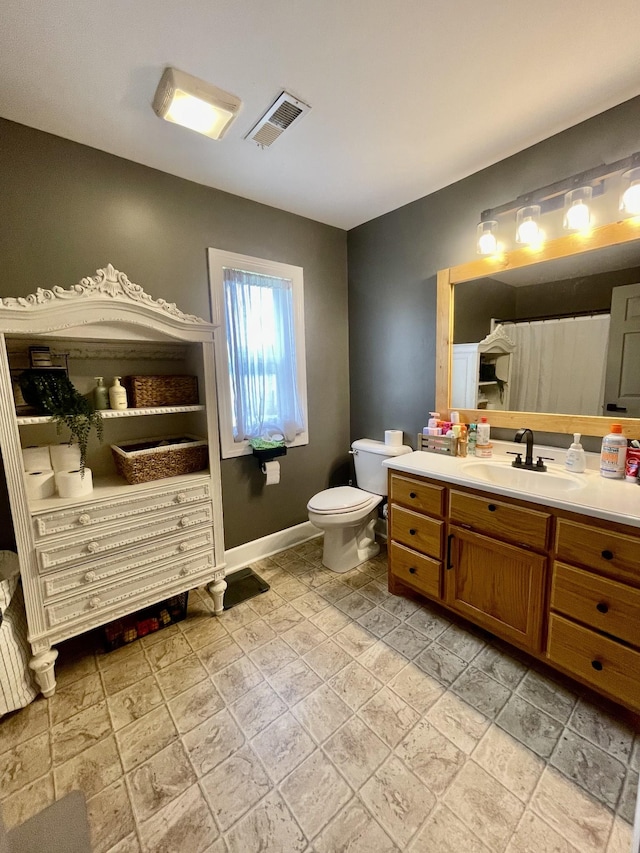233 Shelton Dr, Saint Joseph, TN 38481 - full bathroom featuring vanity, stone tile floors, toilet, and baseboards