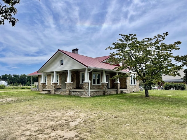 233 Shelton Dr, Saint Joseph, TN 38481 - craftsman-style house with stone siding, a chimney, metal roof, and a porch