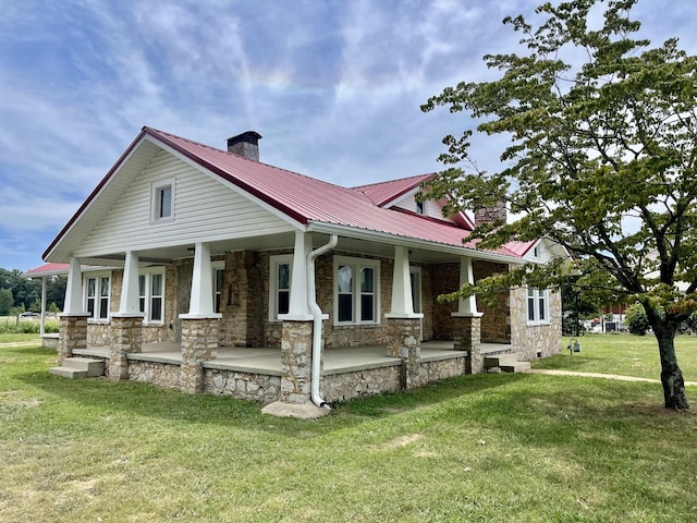 233 Shelton Dr, Saint Joseph, TN 38481 - craftsman inspired home with stone siding, a chimney, covered porch, metal roof, and a front yard