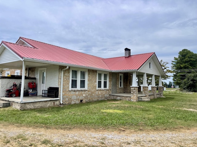 233 Shelton Dr, Saint Joseph, TN 38481 - view of front of property featuring covered porch, a chimney, metal roof, and a front yard