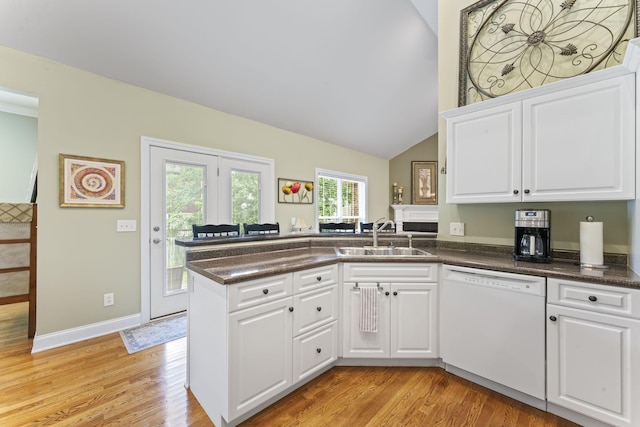551 Bethany Cir, Murfreesboro, TN 37128 - kitchen with dishwasher, a sink, a peninsula, light wood-style flooring, and dark countertops