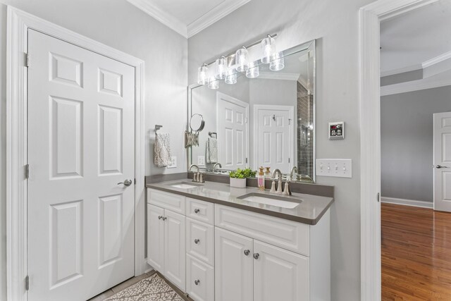551 Bethany Cir, Murfreesboro, TN 37128 - full bathroom featuring crown molding, double vanity, wood finished floors, and baseboards