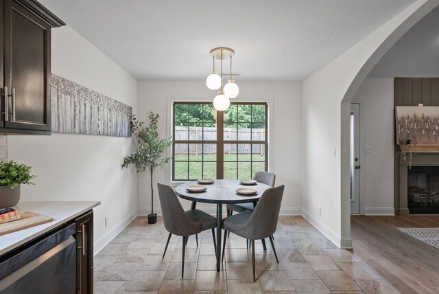 1021 Charles Thomas Dr, Clarksville, TN 37042 - dining space featuring arched walkways, baseboards, and a glass covered fireplace