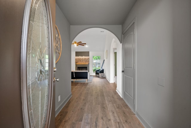 1021 Charles Thomas Dr, Clarksville, TN 37042 - hall with arched walkways, wood finished floors, and baseboards