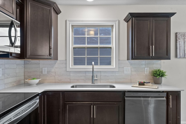 1021 Charles Thomas Dr, Clarksville, TN 37042 - kitchen featuring stainless steel dishwasher, a sink, dark brown cabinets, tasteful backsplash, and light countertops