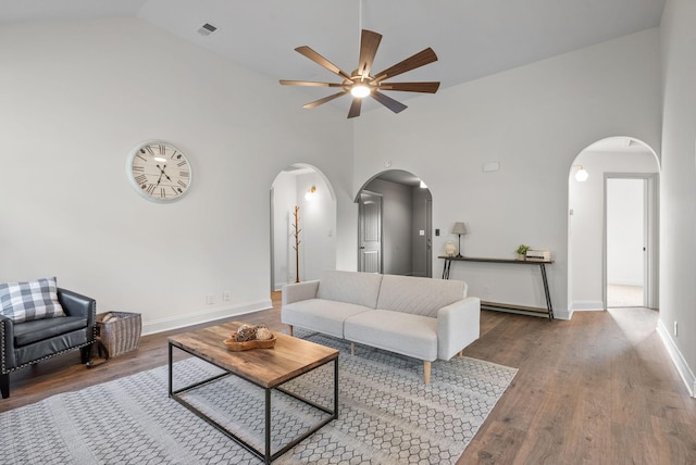 1021 Charles Thomas Dr, Clarksville, TN 37042 - living room with arched walkways, a ceiling fan, wood finished floors, baseboards, and high vaulted ceiling